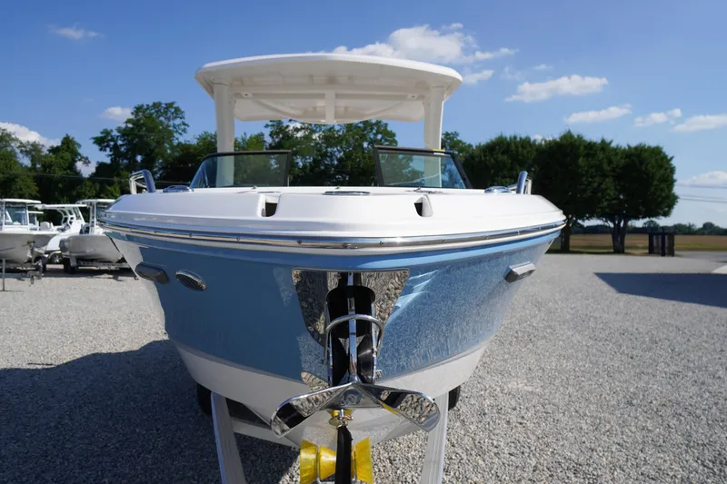 Slide: The Image of 2026 Chaparral 270 OSX boat displayed outdoors on gravel lot. - 82