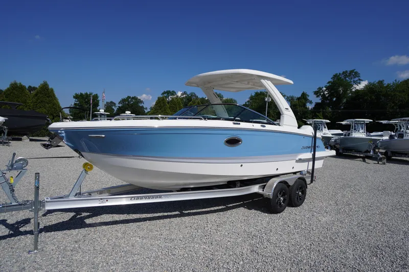Slide: The Image of 2026 Chaparral 270 OSX boat on trailer, displayed outdoors under clear blue sky. - 1