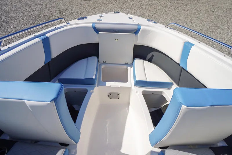 Slide: The Image of 2026 Chaparral 270 OSX boat interior with blue and white seating and storage compartments. - 16