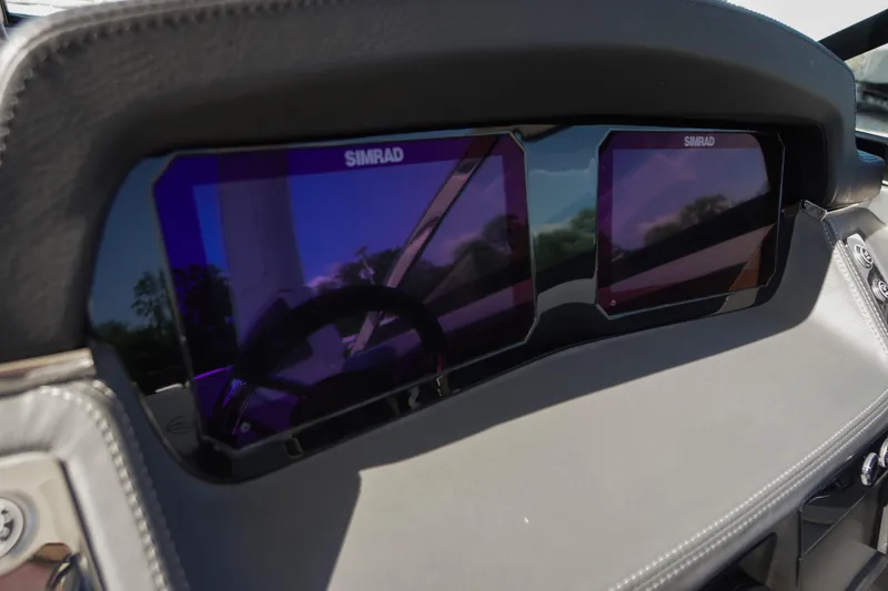 Slide: The Image of Dashboard of 2026 Chaparral 270 OSX featuring dual Simrad displays. - 65