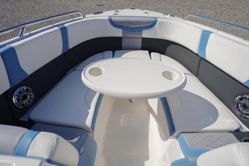 Slide: The Image of Luxurious seating area on the 2026 Chaparral 270 OSX boat with table and speakers. - 35