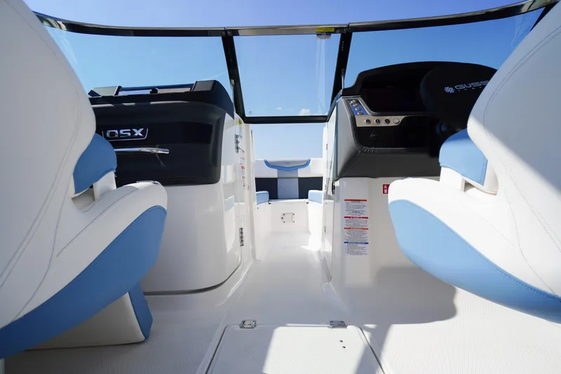 Slide: The Image of 2026 Chaparral 270 OSX boat interior with modern seating and sleek dashboard design. - 24