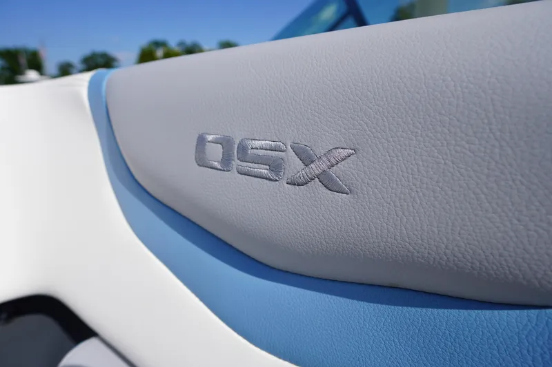 Slide: The Image of Close-up of 2026 Chaparral 270 OSX boat interior with embossed "OSX" logo. - 8