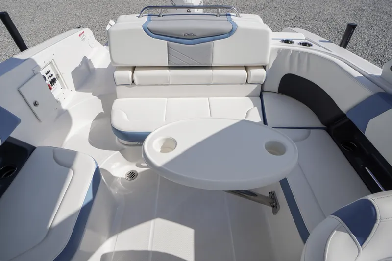 Slide: The Image of 2026 Chaparral 270 OSX boat interior with white seating and round table. - 36