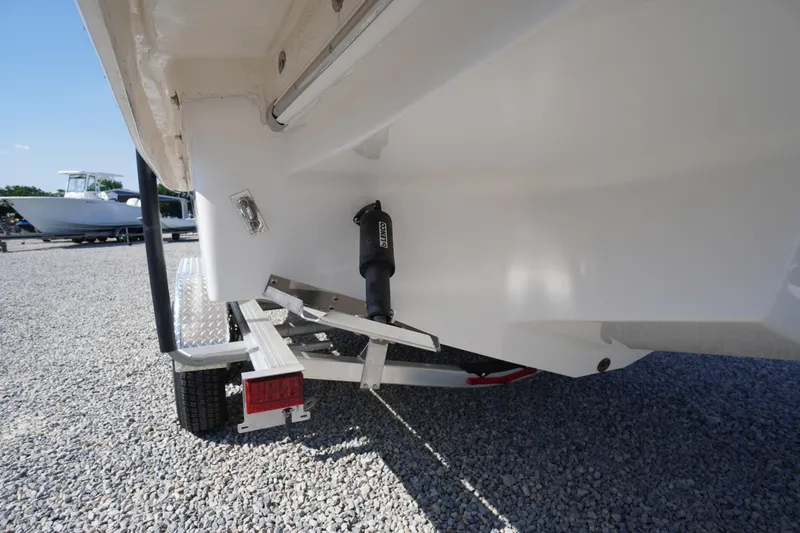 Slide: The Image of 2026 Chaparral 270 OSX boat on trailer, rear view showing hull and trim tab. - 72