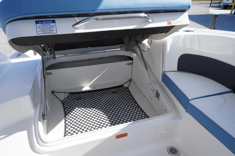 Slide: The Image of Open storage compartment on 2026 Chaparral 270 OSX boat with cushioned seating. - 52