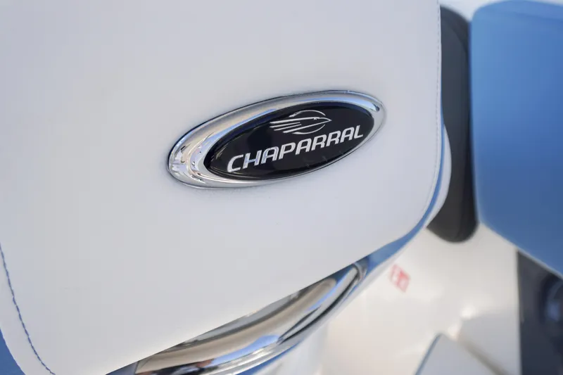 Slide: The Image of Close-up of 2026 Chaparral 270 OSX logo on white and blue upholstery. - 55