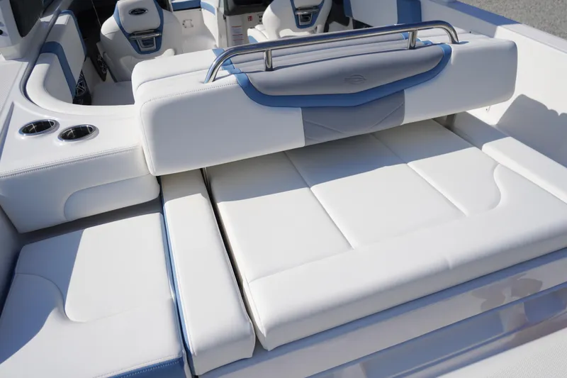Slide: The Image of 2026 Chaparral 270 OSX boat interior with luxurious white seating and cup holders. - 56