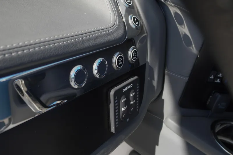 Slide: The Image of Control panel of 2026 Chaparral 270 OSX boat with buttons and Lenco trim tab switches. - 66