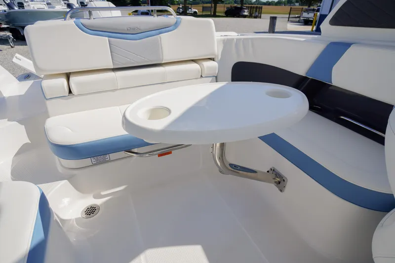 Slide: The Image of 2026 Chaparral 270 OSX boat interior with white seating and a round table. - 39