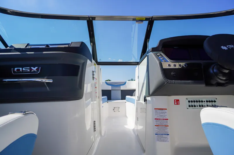 Slide: The Image of Interior view of 2026 Chaparral 270 OSX boat cockpit with modern controls and seating. - 25