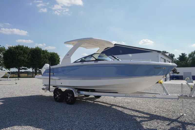 Slide: The Image of 2026 Chaparral 270 OSX boat on trailer, parked outdoors under clear sky. - 80