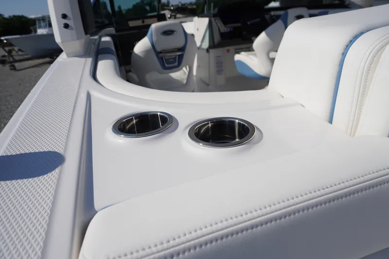 Slide: The Image of 2026 Chaparral 270 OSX boat interior with white seating and stainless steel cup holders. - 58