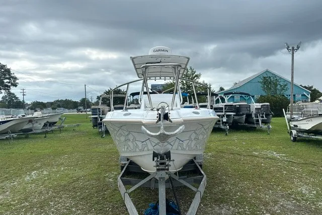 Slide: The Image of 1999 Donzi boat on trailer, parked outdoors under cloudy sky. - 48
