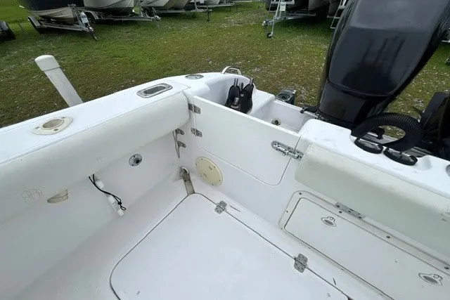 Slide: The Image of 1999 Donzi boat interior with white seating and storage compartments. - 45