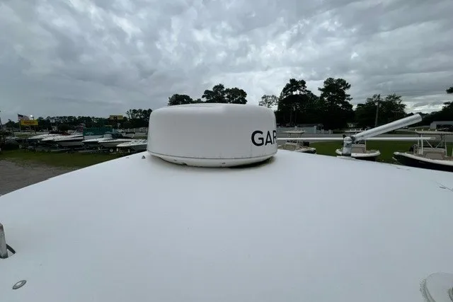 Slide: The Image of Rooftop view of a 1999 Donzi boat with Garmin radar under cloudy skies. - 44