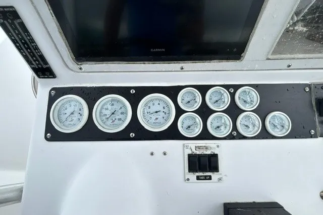 Slide: The Image of 1999 Donzi boat dashboard with gauges and Garmin display. - 28