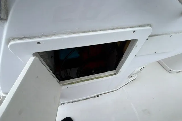 Slide: The Image of 1999 Donzi boat compartment with open hatch, revealing interior storage space. - 39