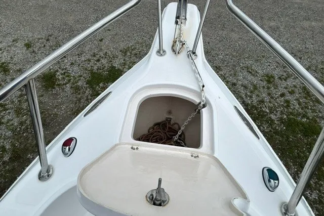 Slide: The Image of 1999 Donzi boat bow with anchor storage and stainless steel railings. - 21