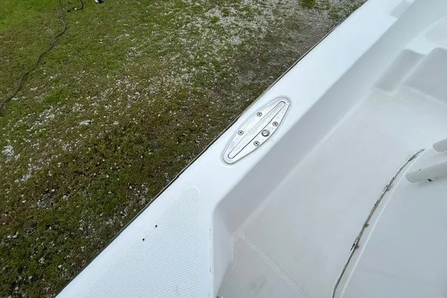 Slide: The Image of 1999 Donzi boat deck detail with cleat, grassy background. - 37