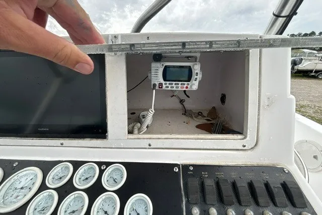 Slide: The Image of 1999 Donzi boat dashboard with gauges, radio, and storage compartment. - 29