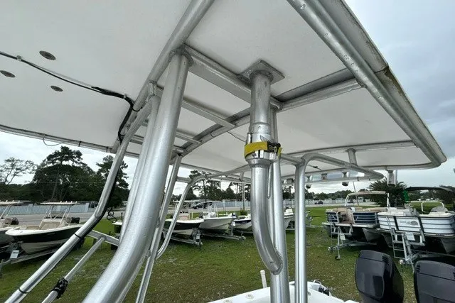 Slide: The Image of 1999 Donzi boat with aluminum T-top frame, parked among other boats on grassy area. - 41