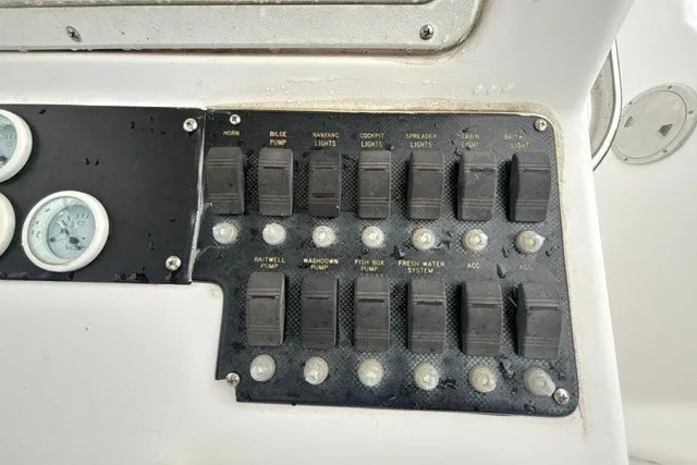 Slide: The Image of Control panel of a 1999 Donzi boat with labeled switches and gauges. - 27