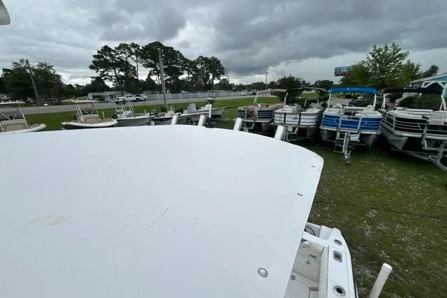 Slide: The Image of Outdoor display of various boats, including a 1999 Donzi, under cloudy skies. - 43