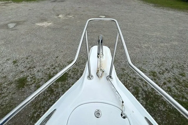 Slide: The Image of Bow of a 1999 Donzi boat with anchor and railing, parked on gravel. - 22