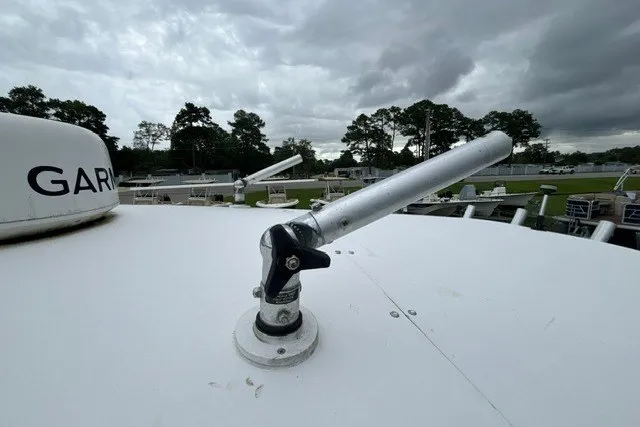 Slide: The Image of Antenna on 1999 Donzi boat under cloudy sky, with trees in the background. - 42
