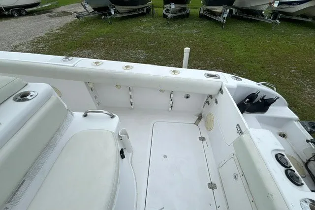 Slide: The Image of 1999 Donzi boat interior with white seating and fishing rod holders. - 36