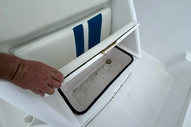 Slide: The Image of 1999 Donzi boat seat storage compartment with blue stripe design. - 25