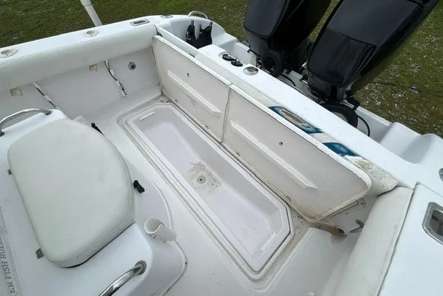 Slide: The Image of 1999 Donzi boat interior with open storage compartment and dual outboard motors. - 33