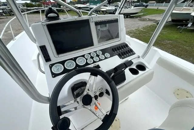 Slide: The Image of 1999 Donzi boat dashboard with steering wheel, gauges, and navigation screens. - 16