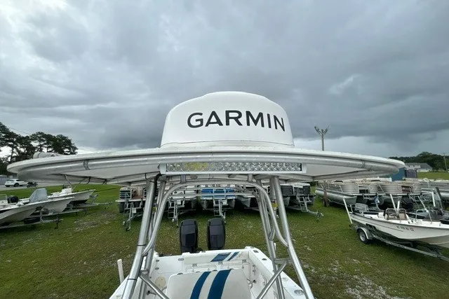Slide: The Image of 1999 Donzi boat with Garmin radar, surrounded by other boats under cloudy skies. - 24