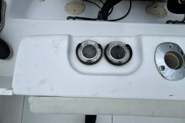 Slide: The Image of 1999 Donzi boat deck with dual fuel caps and rod holder. - 46