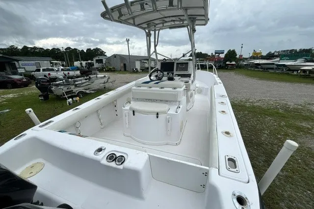 Slide: The Image of 1999 Donzi boat with center console and T-top, parked outdoors on grassy lot. - 12