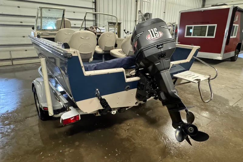Slide: The Image of 2001 Crestliner 1700 boat with 115 HP outboard motor in a garage setting. - 4