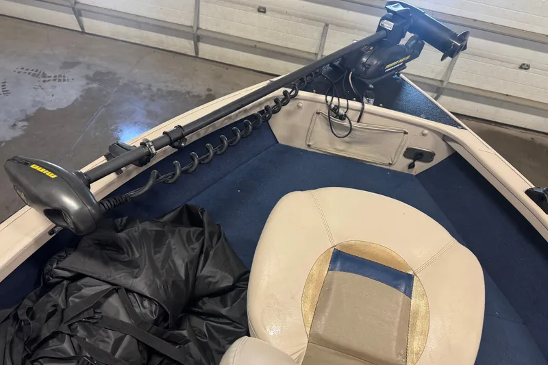 Slide: The Image of 2001 Crestliner 1700 boat interior with trolling motor and beige seat. - 15