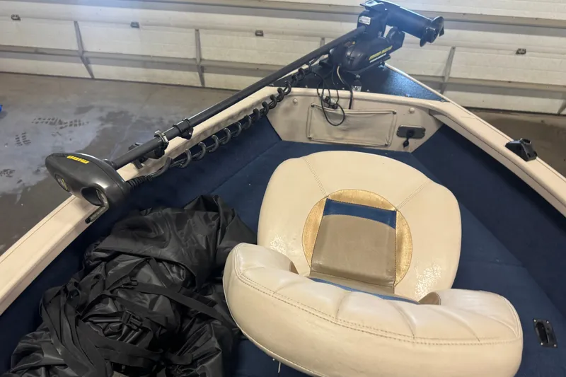Slide: The Image of 2001 Crestliner 1700 boat interior with trolling motor and beige seat. - 13