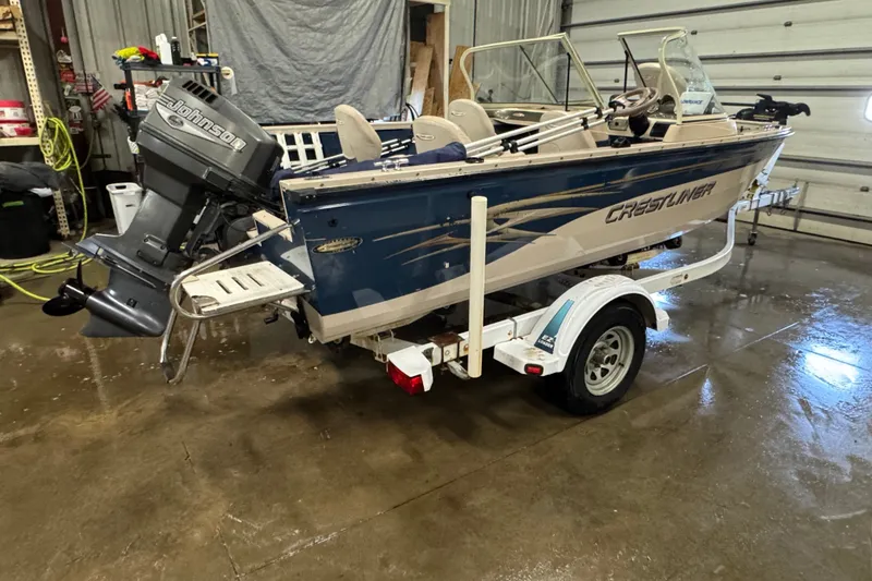 Slide: The Image of 2001 Crestliner 1700 boat with Johnson outboard motor on trailer in garage. - 3