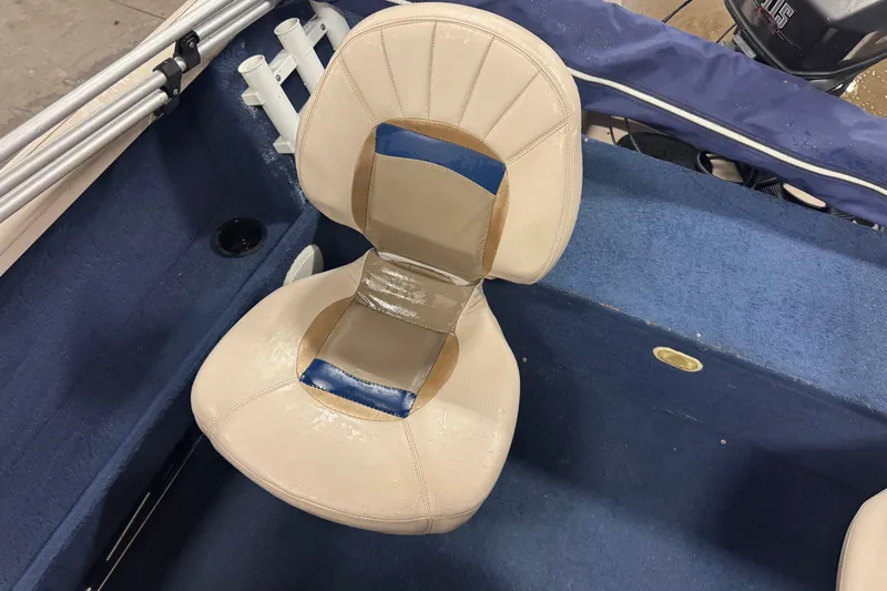 Slide: The Image of Crestliner 1700 boat interior with beige seat, blue carpet, and rod holders, 2001 model. - 11