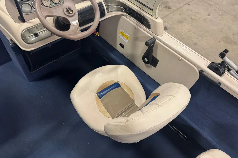 Slide: The Image of Interior of a 2001 Crestliner 1700 boat showing steering wheel and seat. - 5
