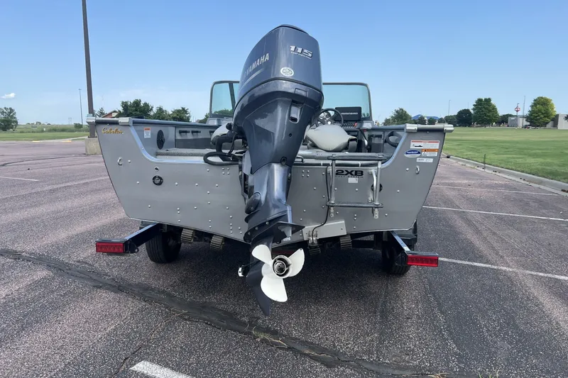 Slide: The Image of 2012 Alumacraft Trophy 175 boat with Yamaha 115 outboard motor in a parking lot. - 3