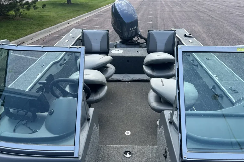 Slide: The Image of 2012 Alumacraft Trophy 175 boat interior with seating and steering console. - 8