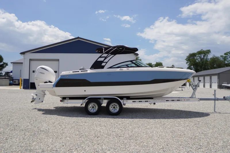 Slide: The Image of 2026 Chaparral SSX 4 boat on trailer, parked outdoors near a building. - 74