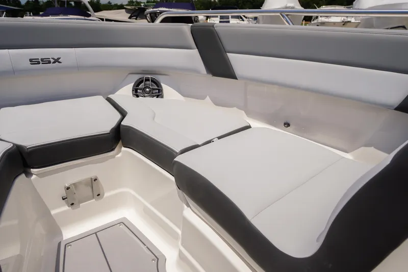 Slide: The Image of Interior seating of 2026 Chaparral SSX 4 boat, featuring sleek gray and white upholstery. - 13