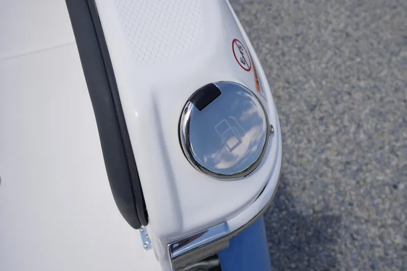 Slide: The Image of Fuel cap on 2026 Chaparral SSX 4 boat, reflecting sky and clouds. - 62