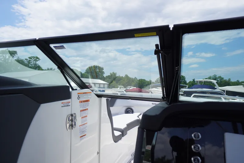 Slide: The Image of 2026 Chaparral SSX 4 boat interior with open windshield and dashboard view. - 19