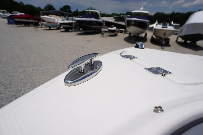 Slide: The Image of 2026 Chaparral SSX 4 boat detail with cleat, surrounded by other boats in a marina. - 12